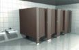 A row of brown toilet cubicles in a public restroom.