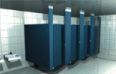 A row of blue toilet cubicles in a public restroom.