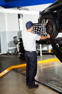 Mechanic doing wheel alignment — Waynesboro, VA — Whitesell Collision Restoration