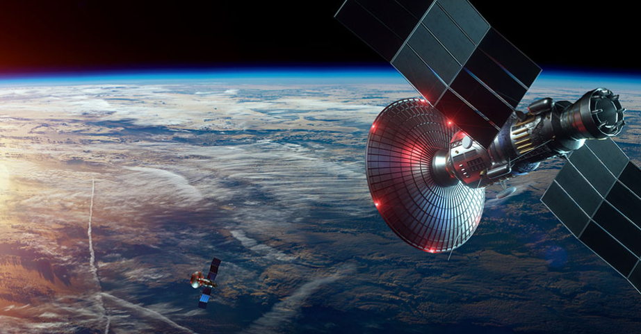 A satellite is flying over the earth in space.