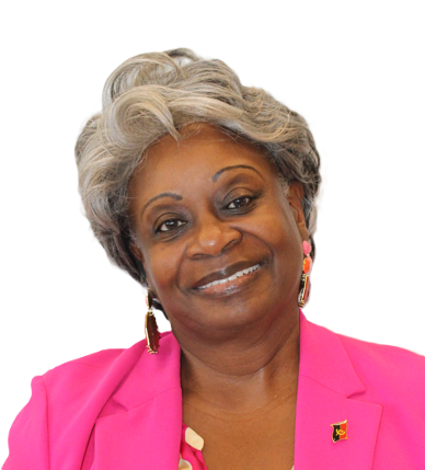Smiling person with gray hair wearing a bright pink blazer and drop earrings, set against a plain white background.