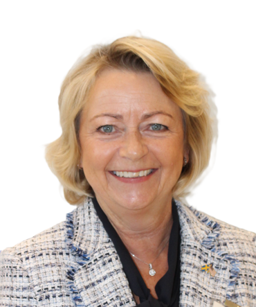 A smiling woman with blonde hair, wearing a black top and a blue and white tweed blazer against a white background.