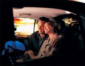 A couple enjoying a comfortable ride to the airport Happy couple in car