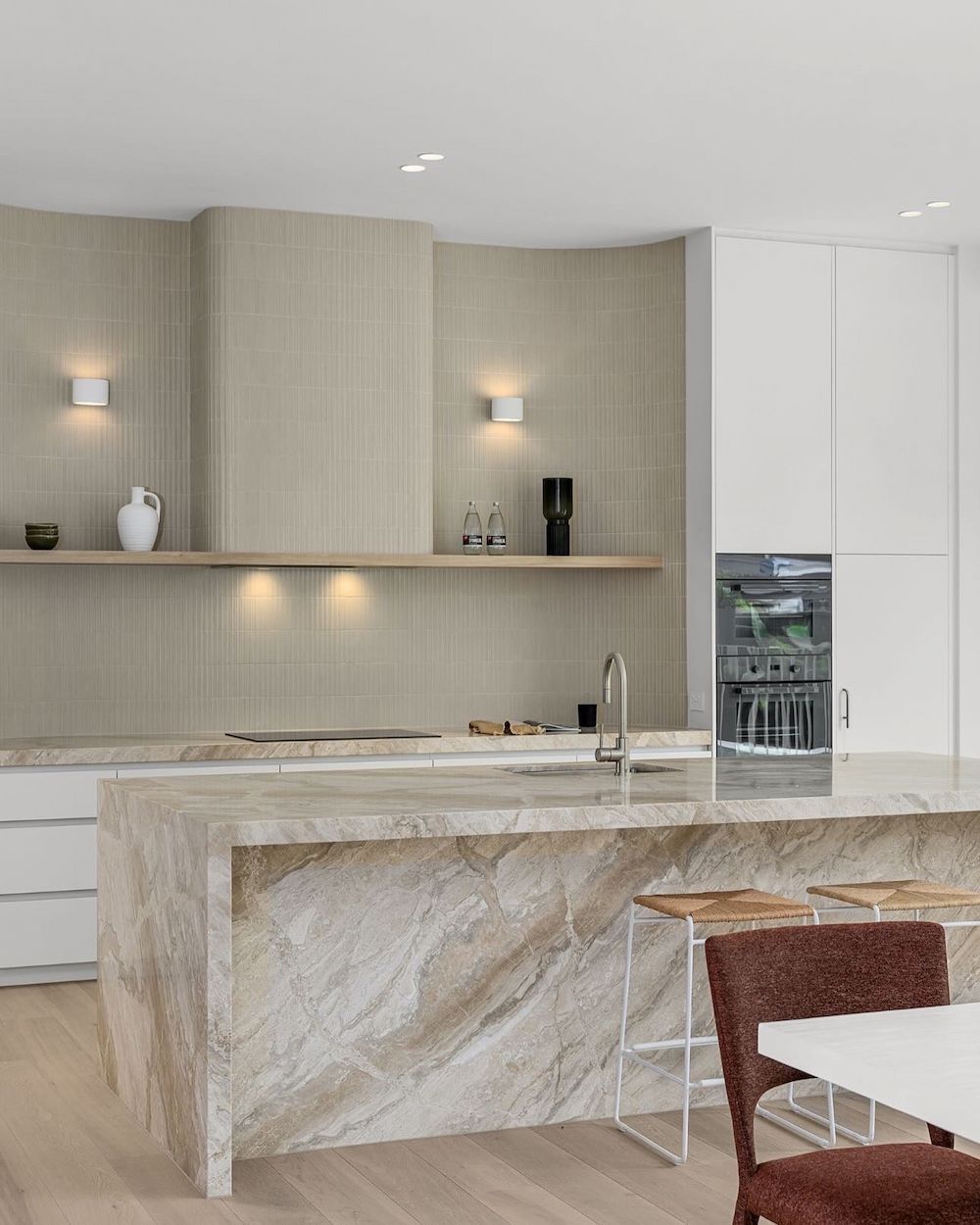 A Kitchen With a Large Island and a Table and Chairs — Hot Rock Granite In Burleigh Heads, QLD