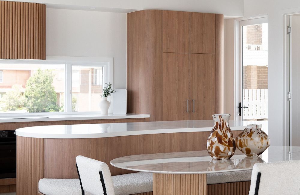 A Kitchen With a Table and Chairs and Vases on the Counter — Hot Rock Granite In Burleigh Heads, QLD