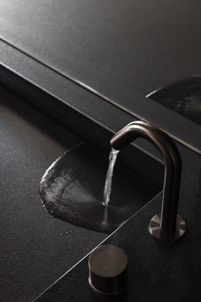 A close up of a sink with water running out of it