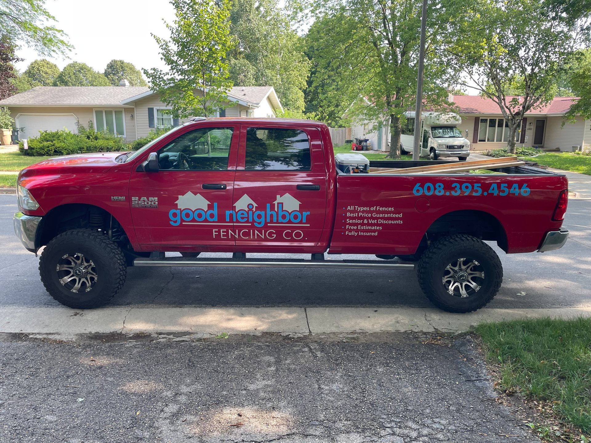 big red truck with Good Neighbor Fencing logo on it