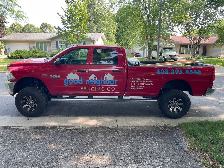 big red truck with Good Neighbor Fencing logo on it