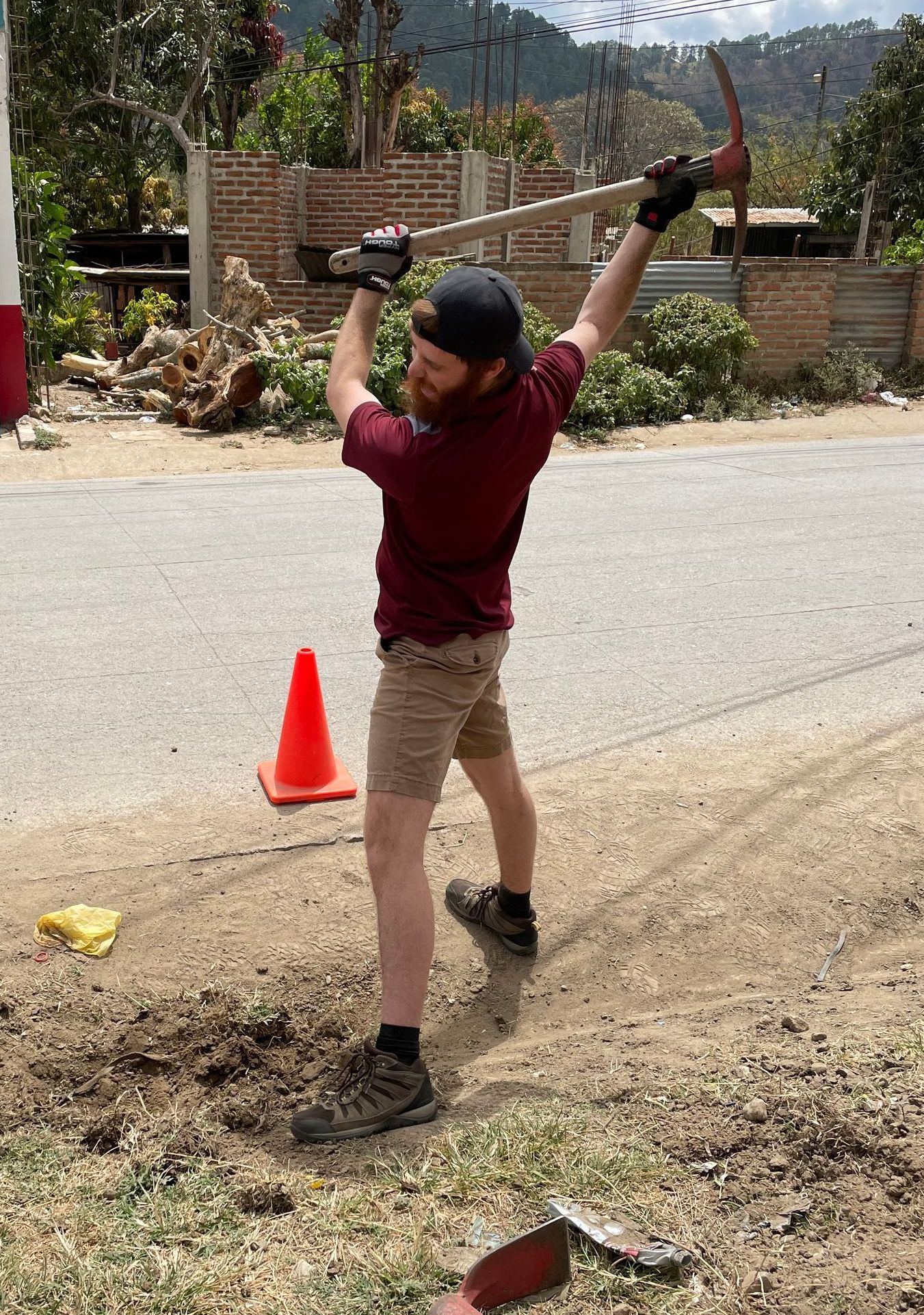 Working along a highway with a pickaxe to prepare for another project
