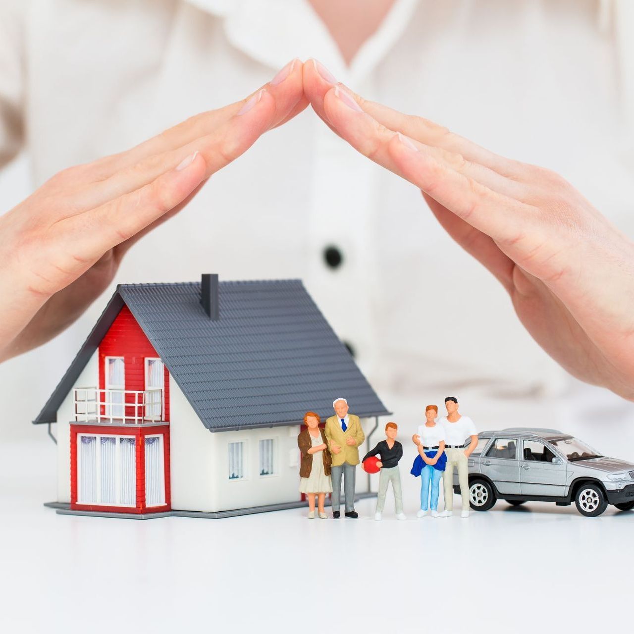 A man and woman are holding a baby on the beach.