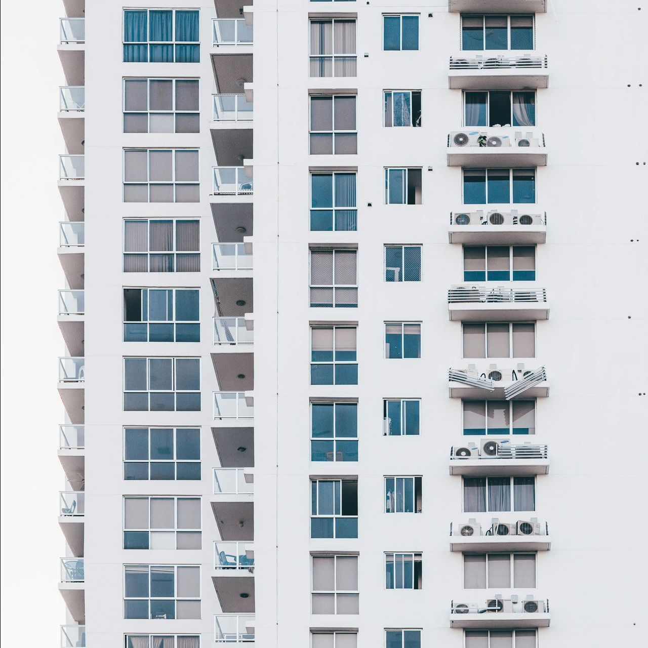 A woman and a child are giving each other a high five while sitting on the roof of a car.