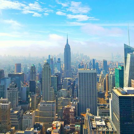 A city skyline with the empire state building in the distance