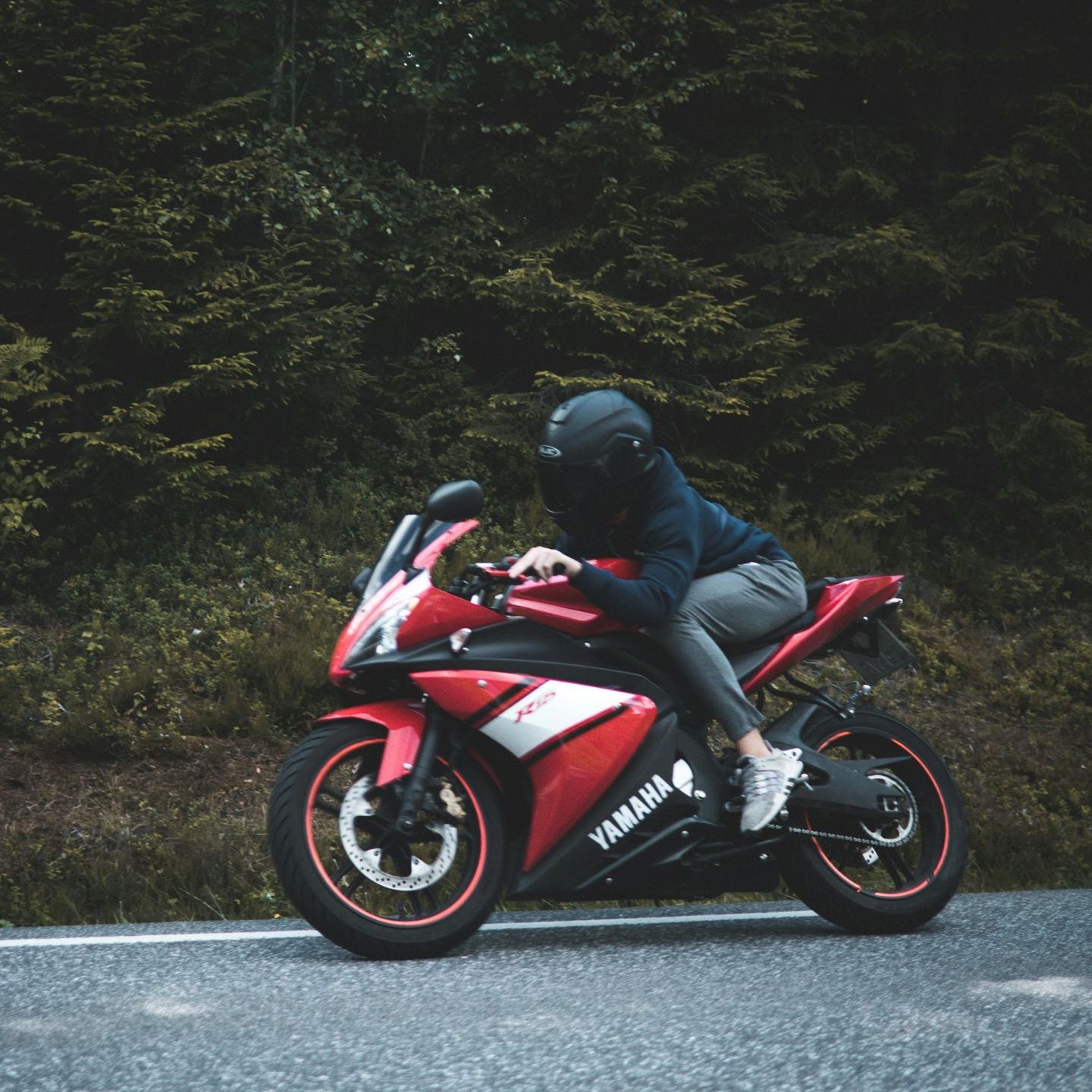 A woman and a child are giving each other a high five while sitting on the roof of a car.