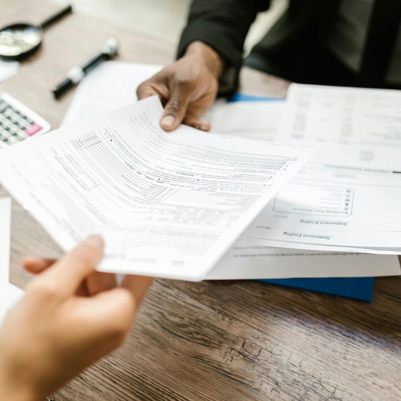 A woman and a child are giving each other a high five while sitting on the roof of a car.