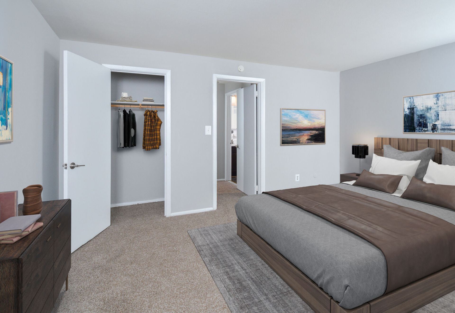 Bedroom in an apartment with a large bed, dresser, and open closet.