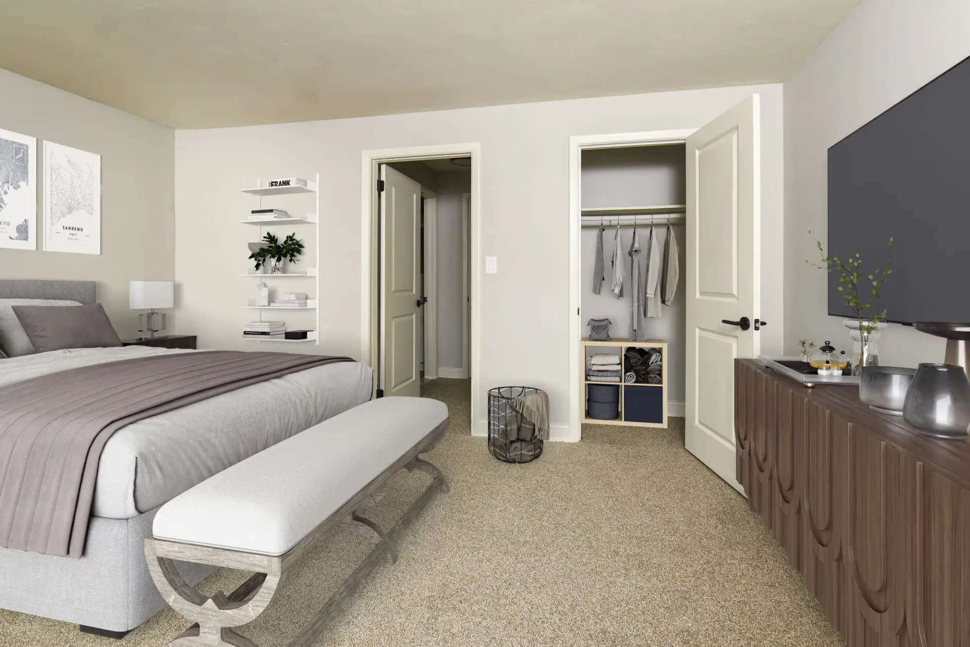 Furnished bedroom in an apartment with a bed, bench at the foot, and open closet.