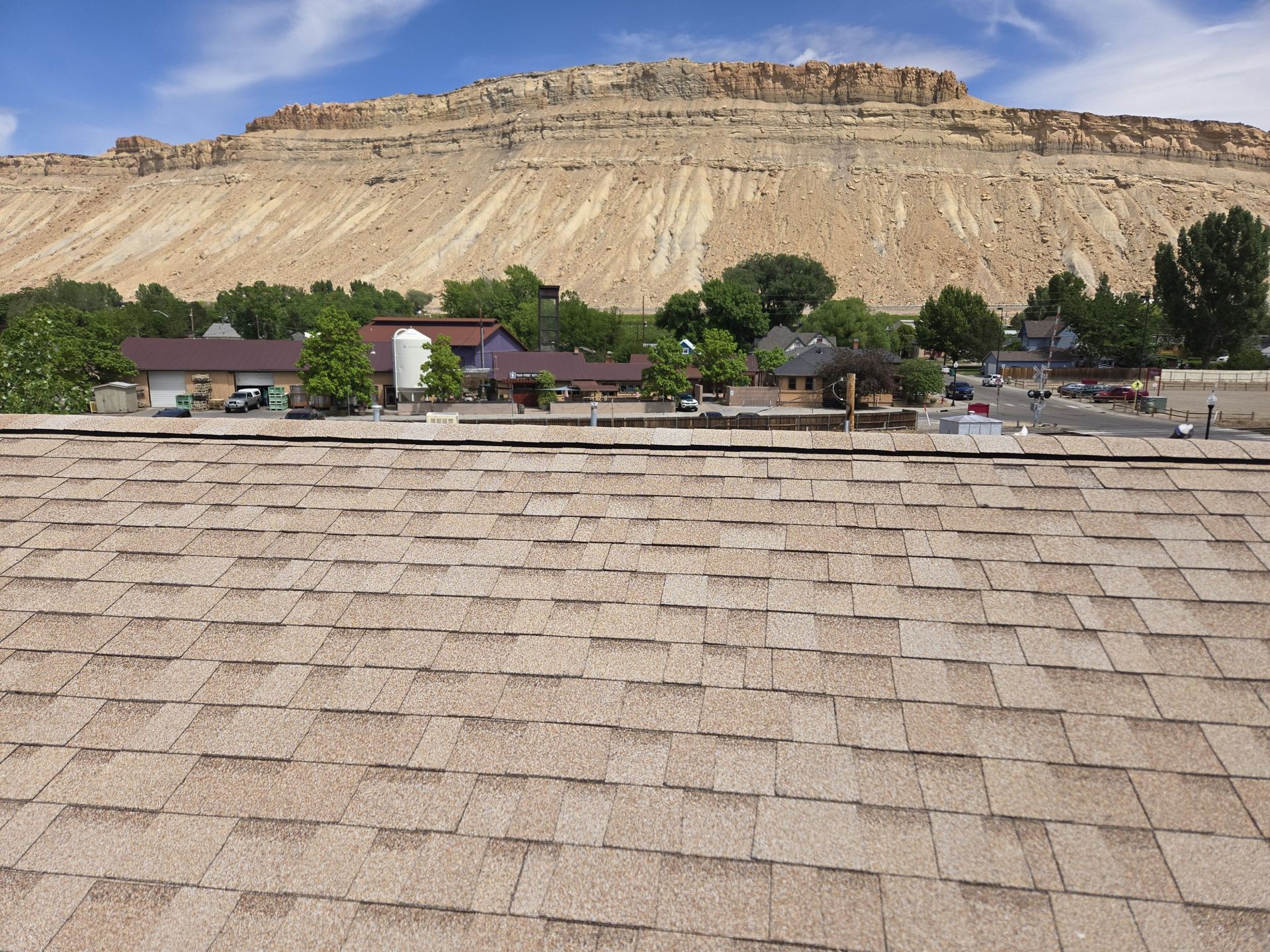 The roof of a house with a mountain in the background