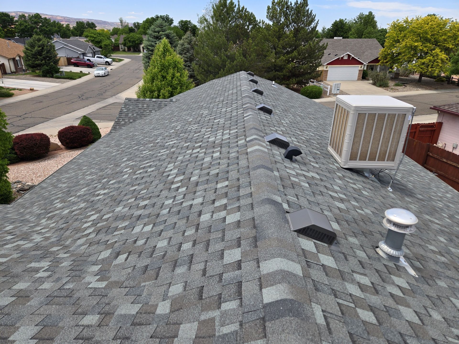 A roof with a fan on top of it in a residential area.