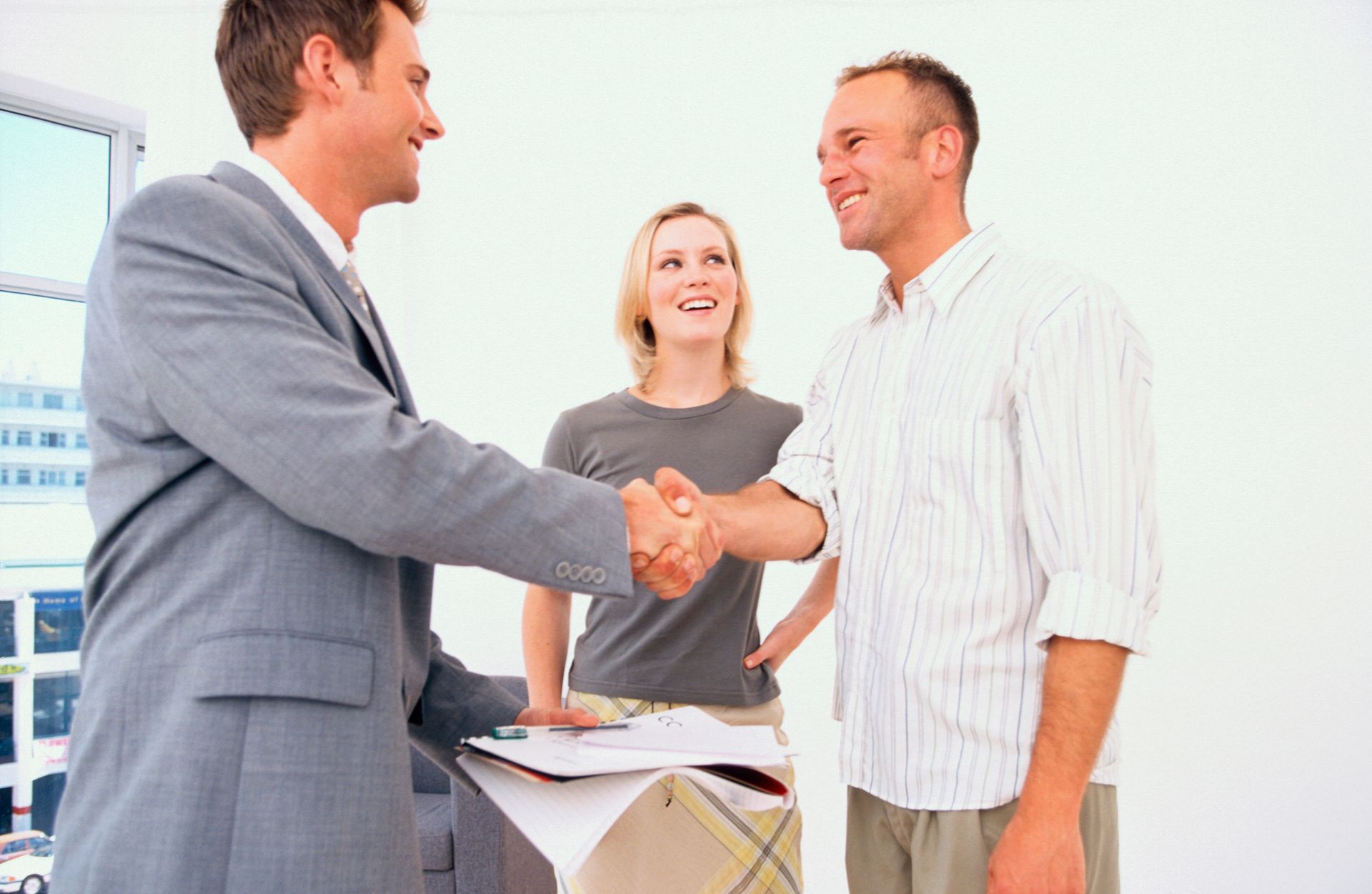 Professional estate planner shaking hands with a client