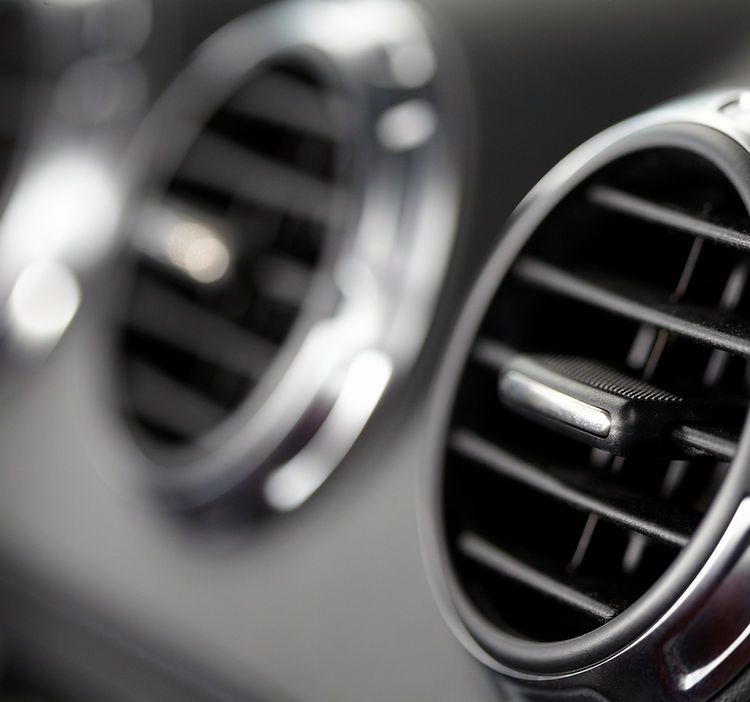 A close up of two air vents in a car