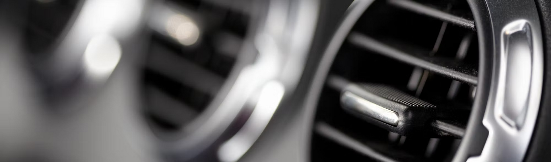 A close up of an air vent in a car.