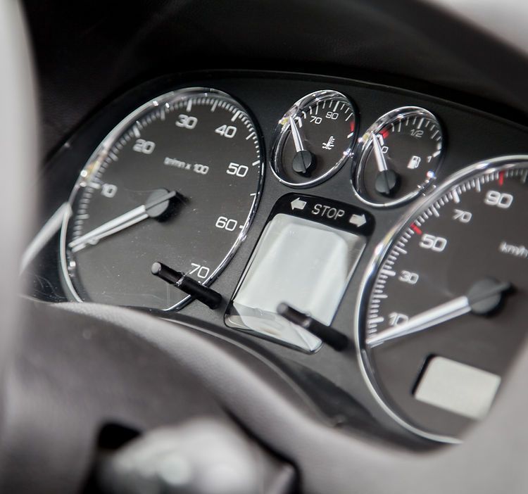 A close up of a car dashboard with a stop button