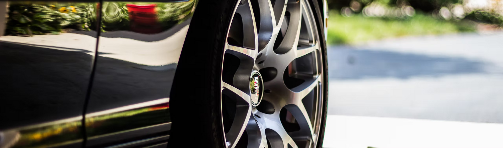 A close up of a car wheel in a garage.