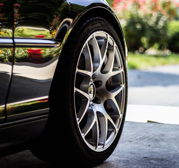 A close up of a car wheel with a silver rim