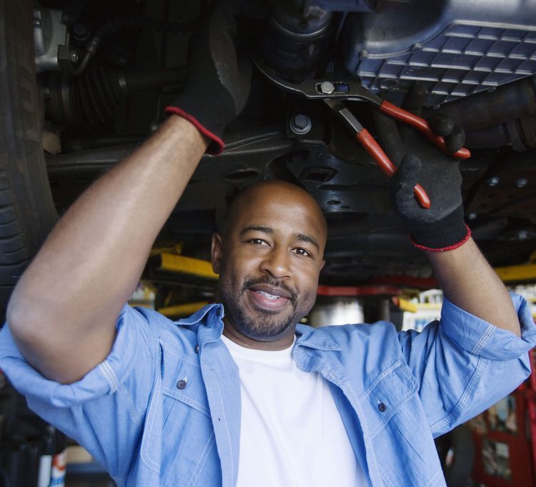 mechanic working under a car