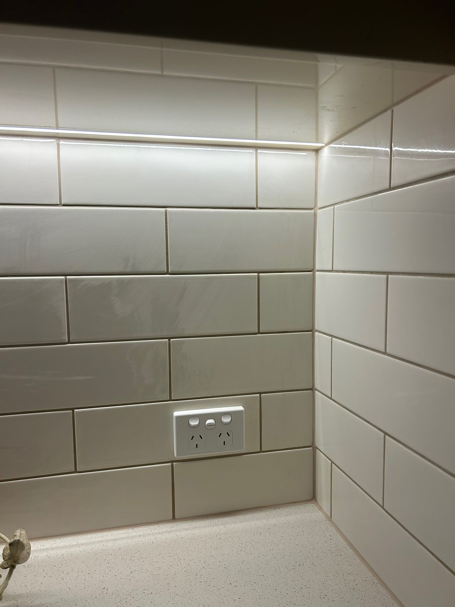 Hands Installing A Lightbulb Into A Ceiling Light Fixture — Fry Electrical In Budgewoi, NSW