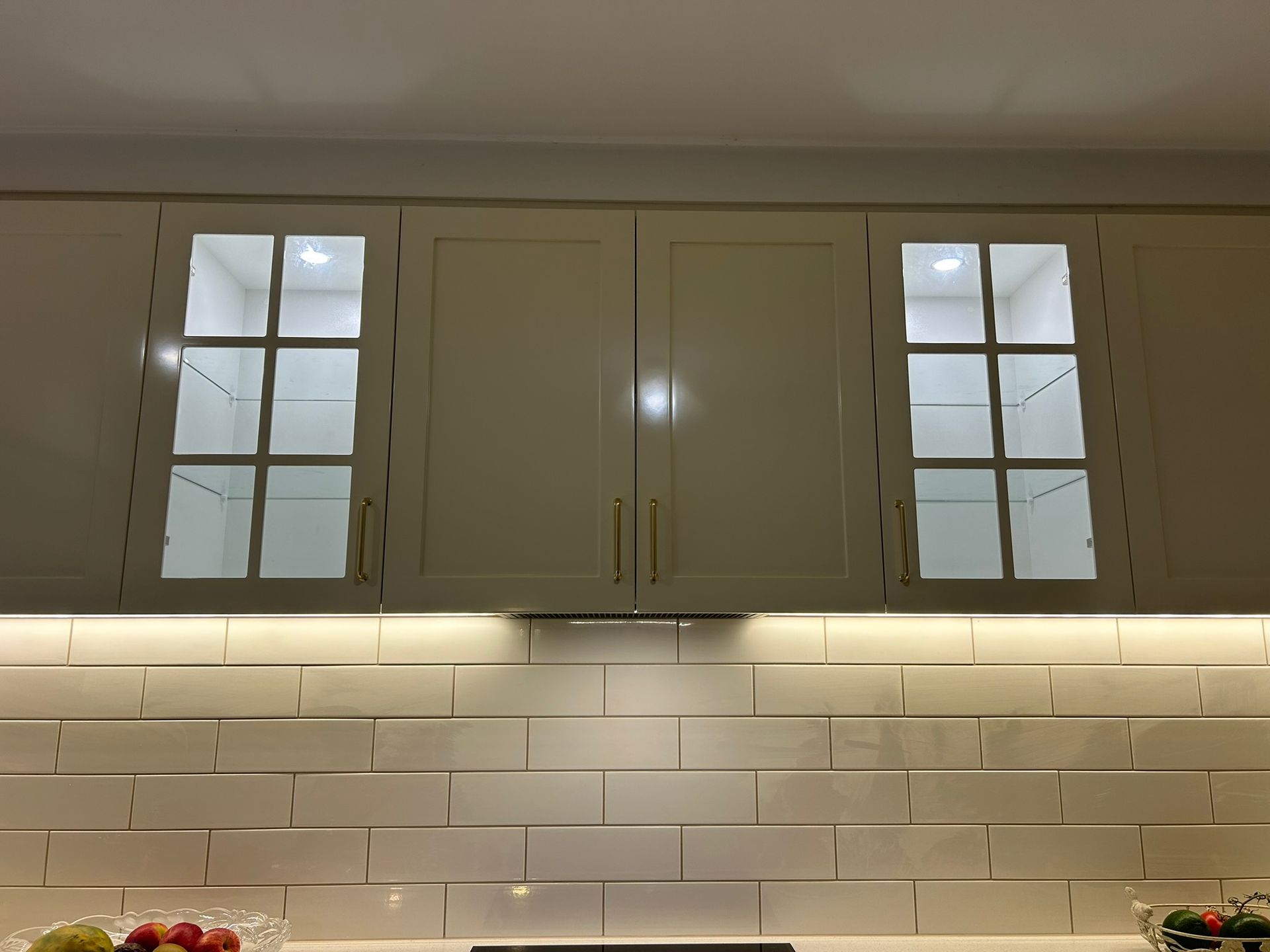 Hands Installing A Lightbulb Into A Ceiling Light Fixture — Fry Electrical In Lake Macquarie, NSW