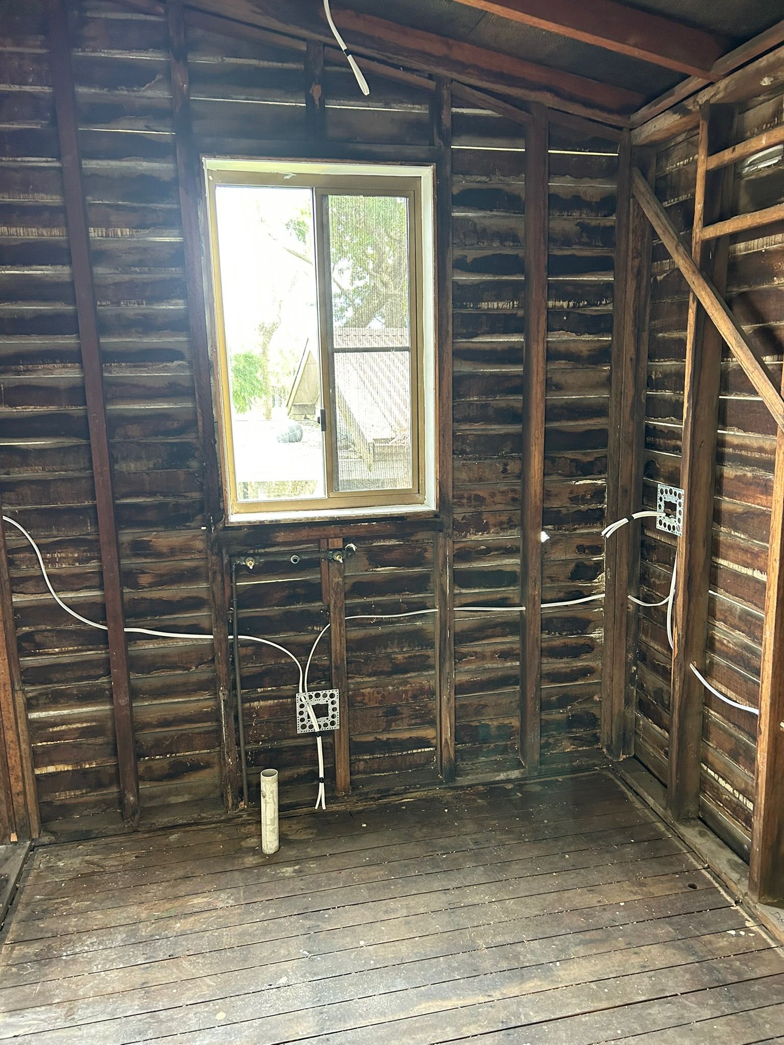 Electrician Holding Coiled Wires And Conduit In A Construction Setting — Fry Electrical In Budgewoi, NSW
