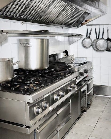 A kitchen with pots and pans on the stove