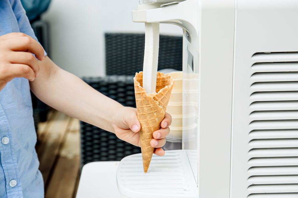 Woman Eating an Ice Cream Using a Plastic Spoon — Frosty Whip in Rasmussen, QLD