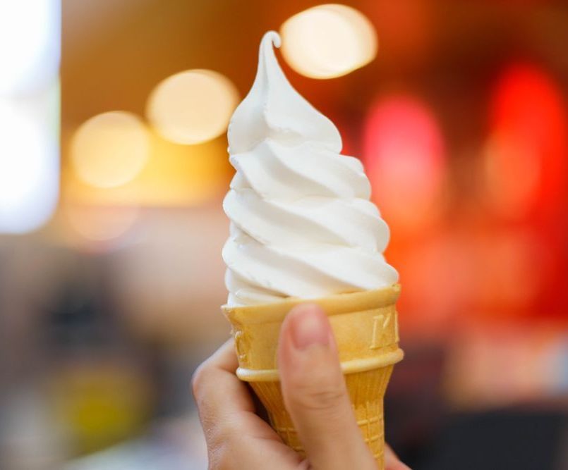 A Woman Holding an Ice Cream Cone — Frosty Whip in Rasmussen, QLD