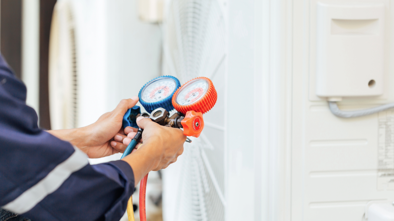 A man is holding a couple of gauges in his hands.