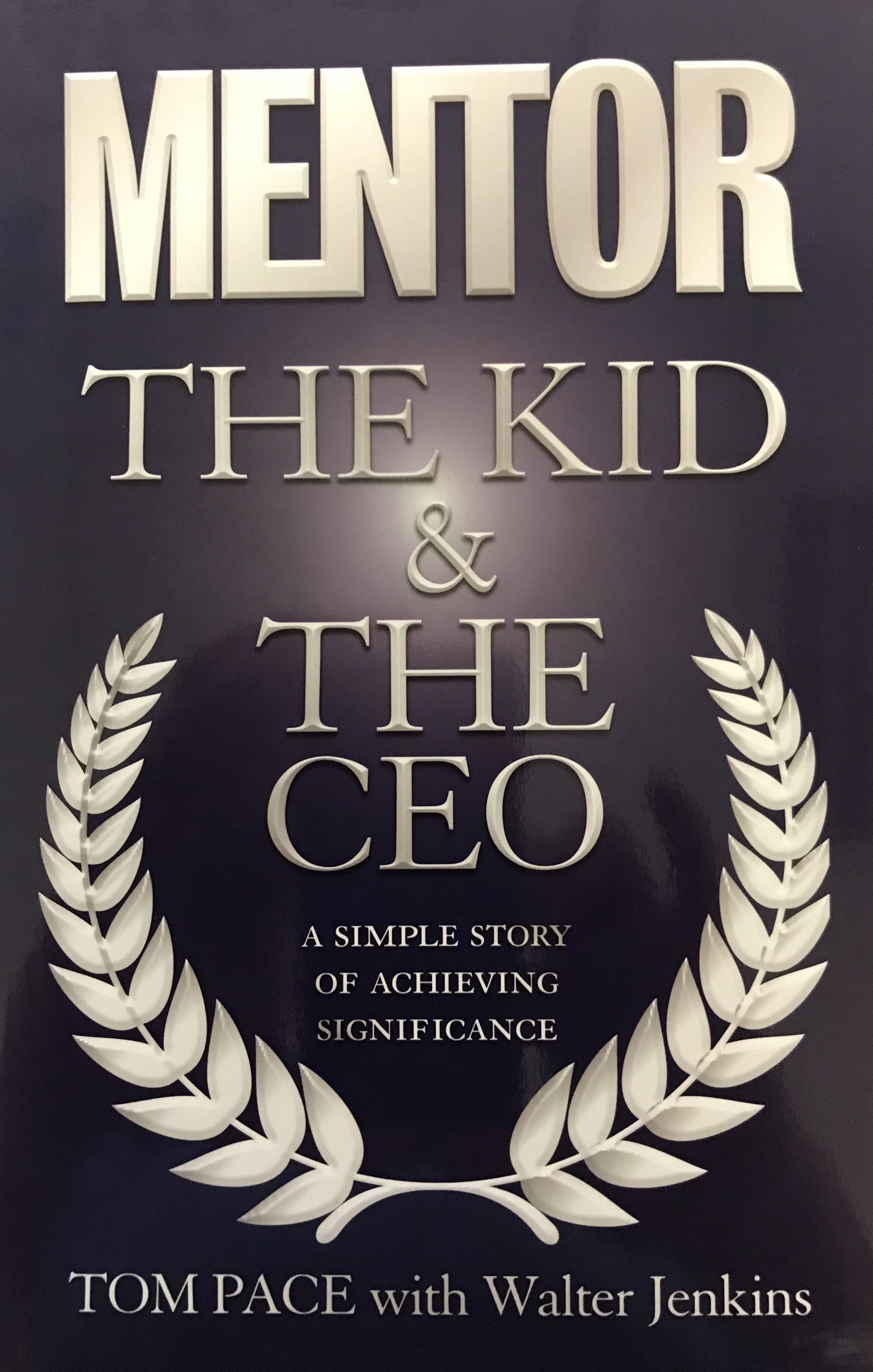 A book titled mentor the kid and the ceo