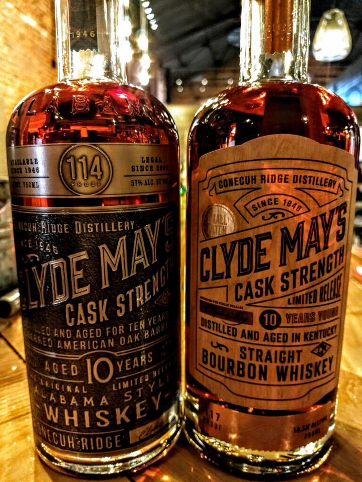 Two bottles of whiskey are sitting next to each other on a table.