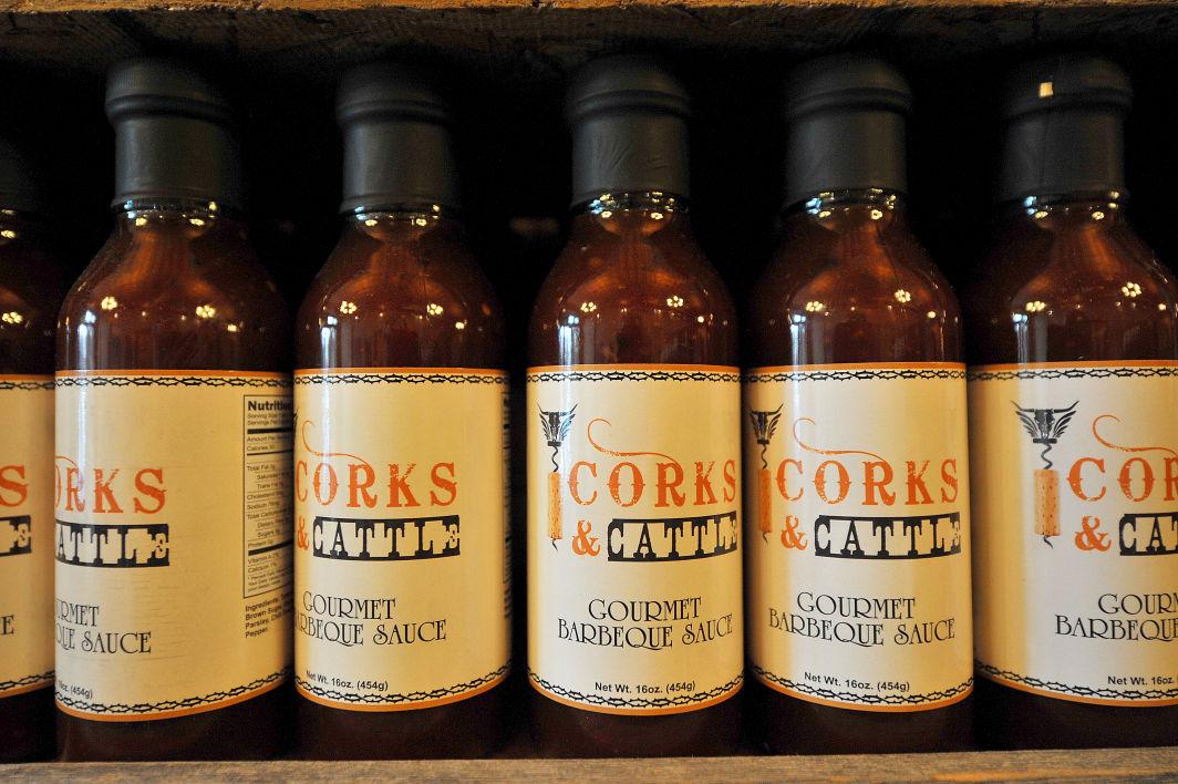 Several bottles of cork sauce are lined up on a shelf