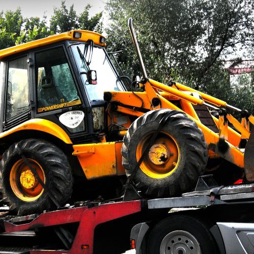 A yellow tractor with the word powercraft on it