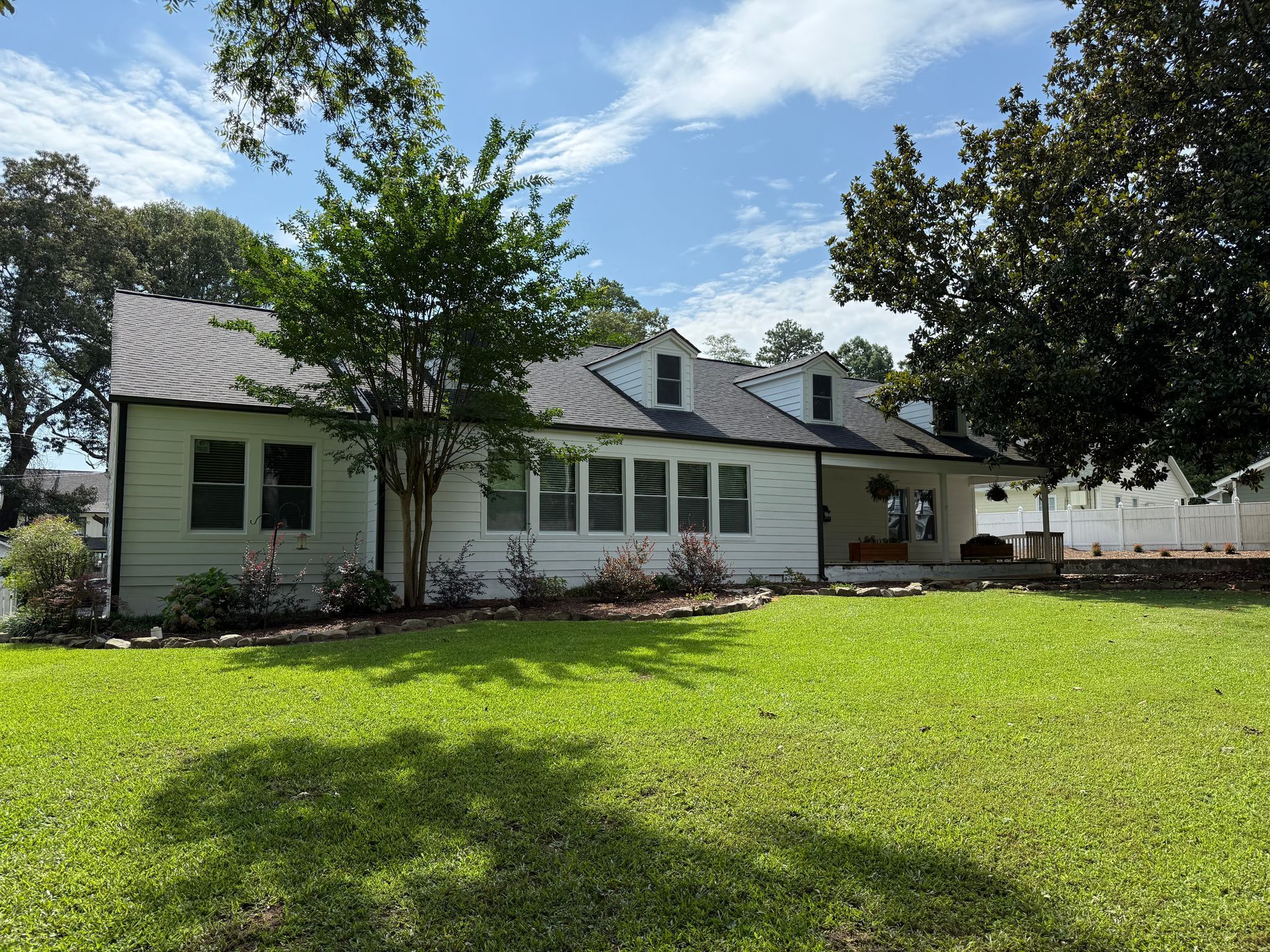 Exterior painting project completed with new black gutters
