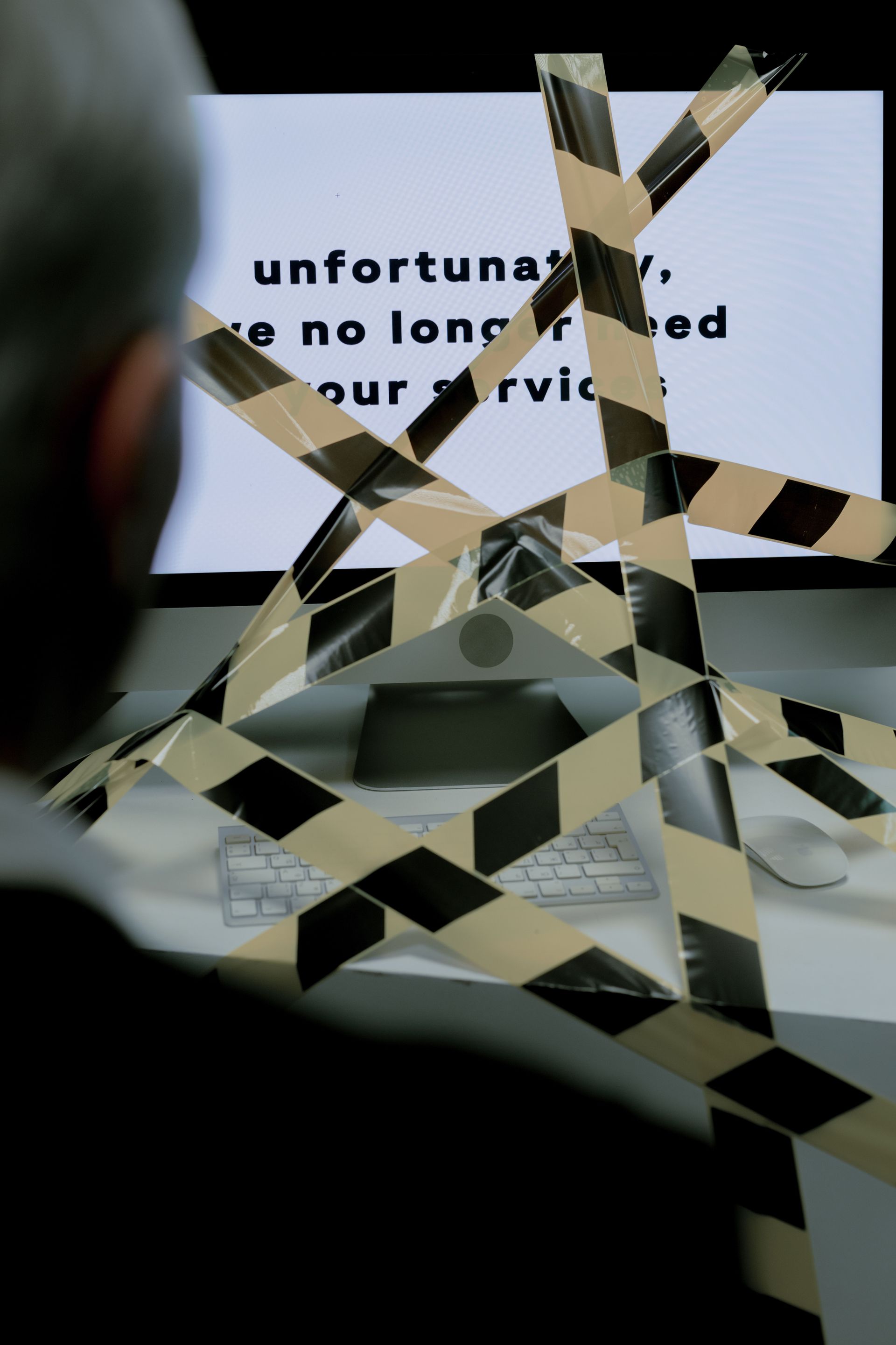 Tape crisscrossing a sign that reads “unfortunately we no longer offer our services”