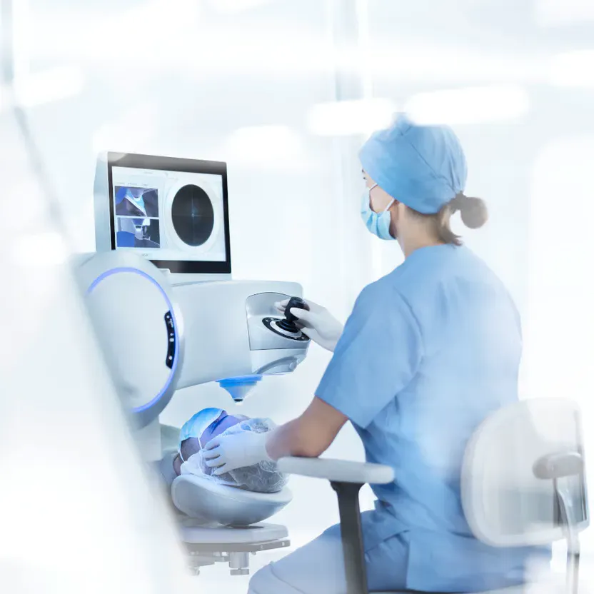 Woman in medical attire operating a computer