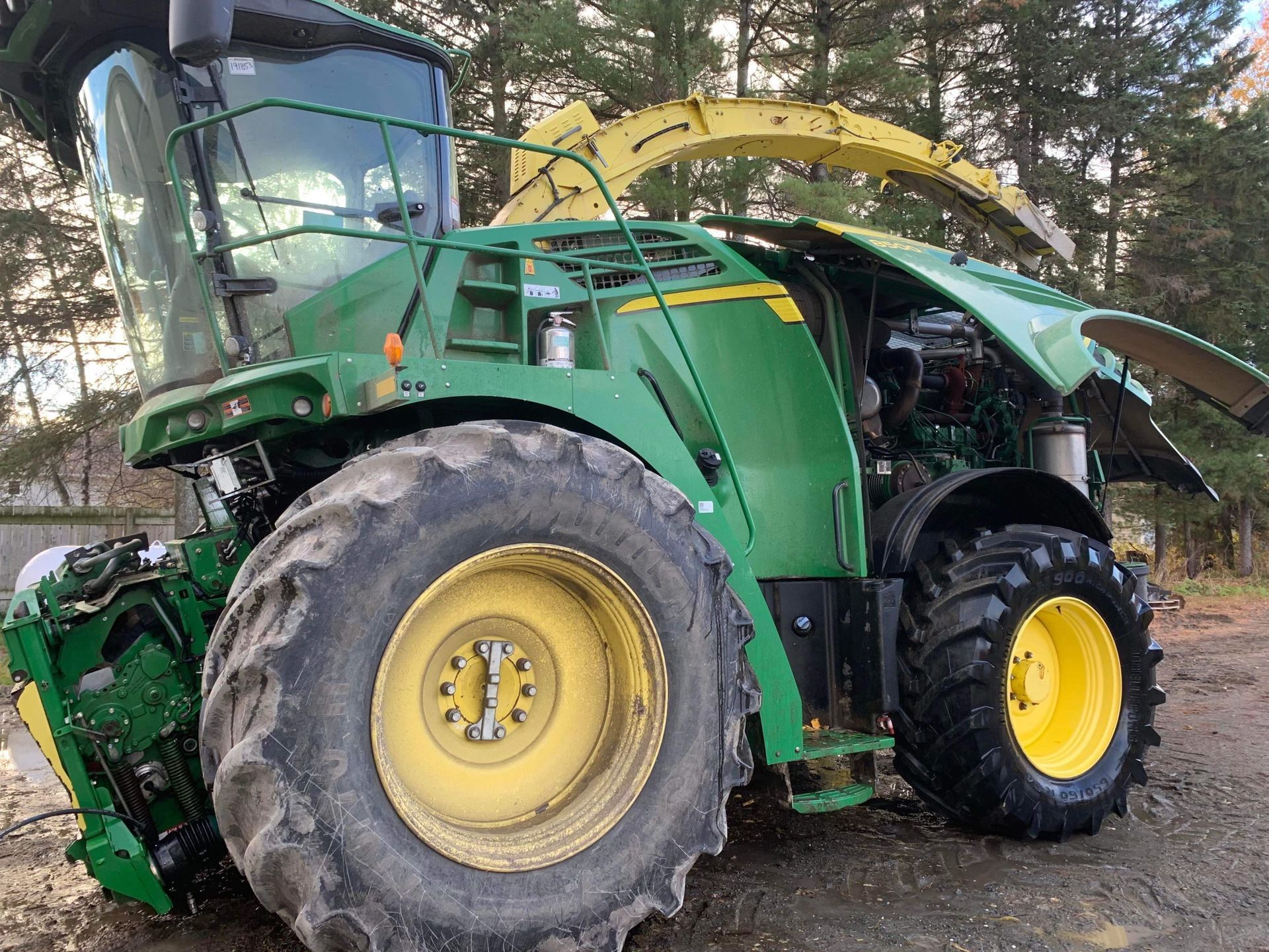 Un tracteur John Deere vert et jaune est garé dans la terre.