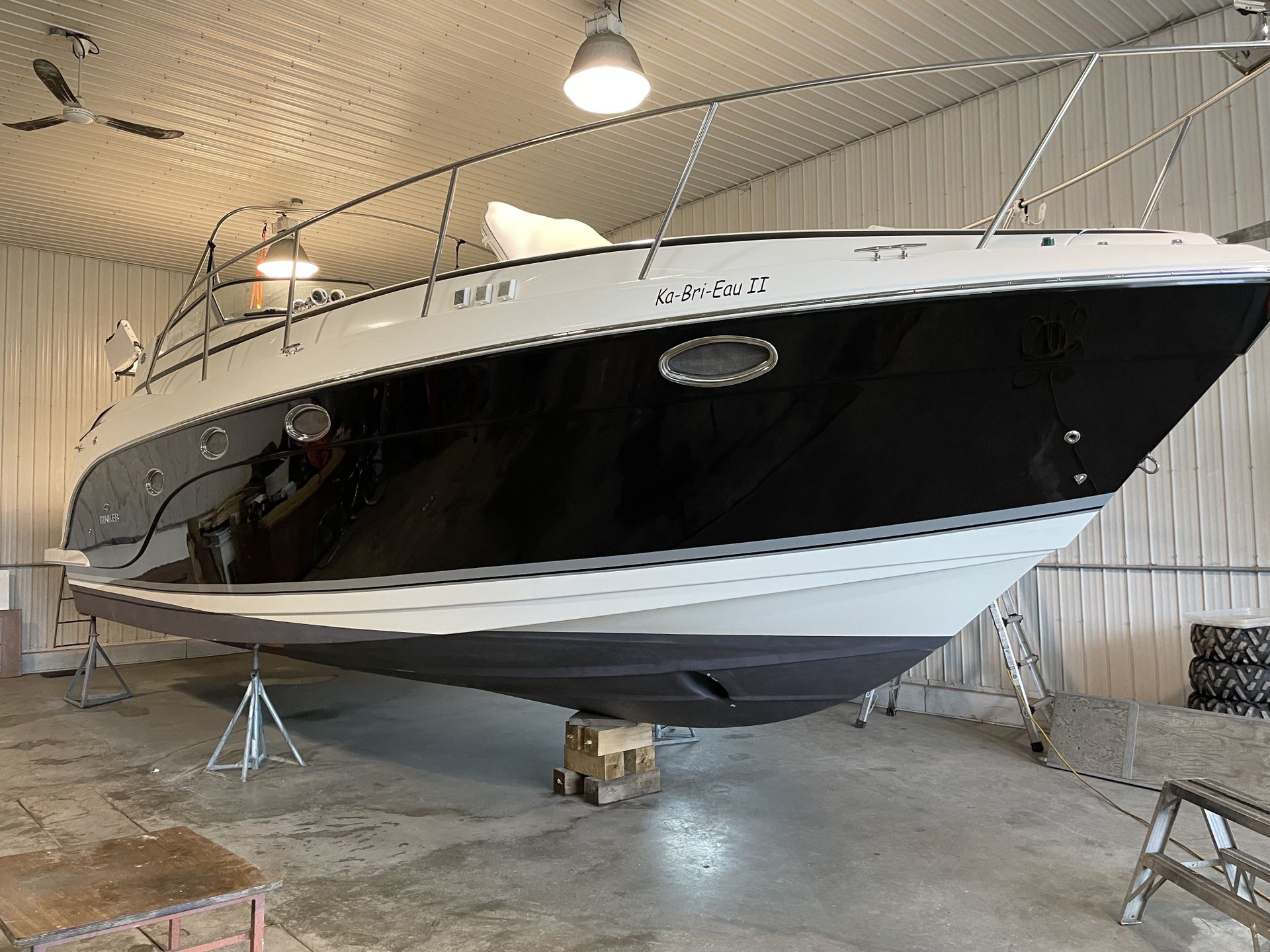 Un bateau noir et blanc se trouve dans un garage.