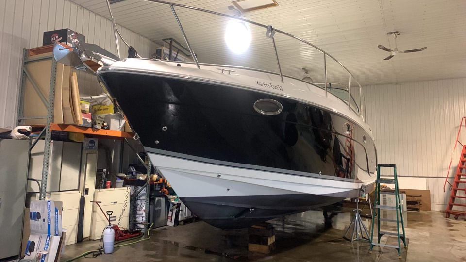 Un bateau noir et blanc se trouve dans un garage.