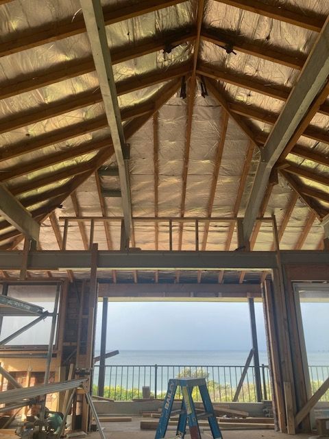 A large house with a lot of windows and a balcony. — Brad Griffiths Building In Culburra Beach, NSW