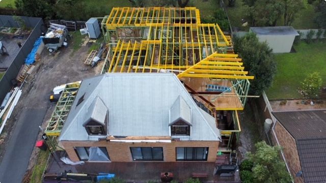 A House Under Construction With Scaffolding On The Roof — Brad Griffiths Building In Culburra Beach, NSW