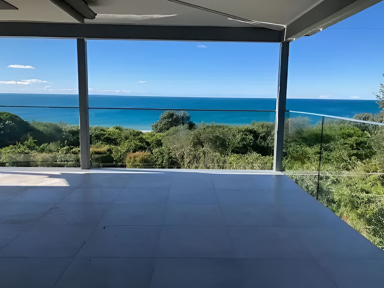 A Balcony With A View Of The Ocean And Trees — Brad Griffiths Building In Culburra Beach, NSW
