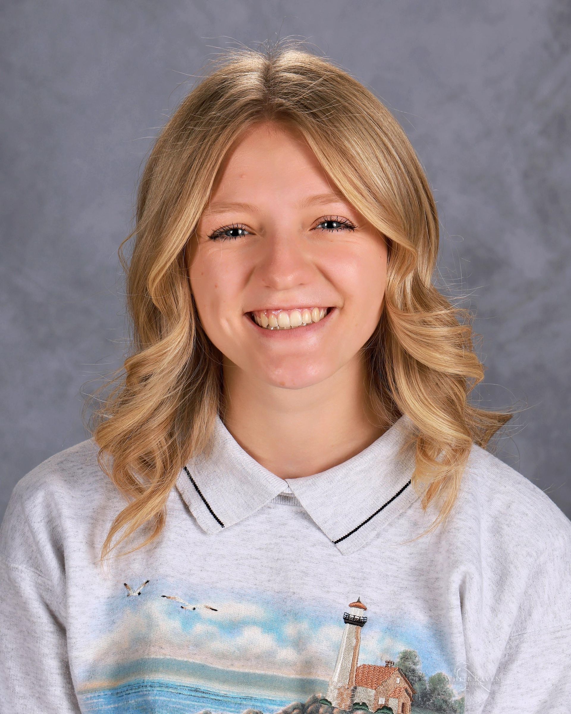 Woman in white shirt smiling for camera